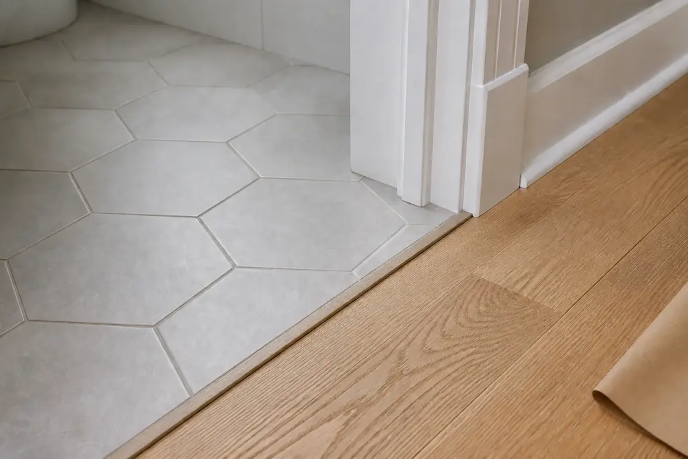 Tile-to-wood transition with straight alignment and consistent grout.